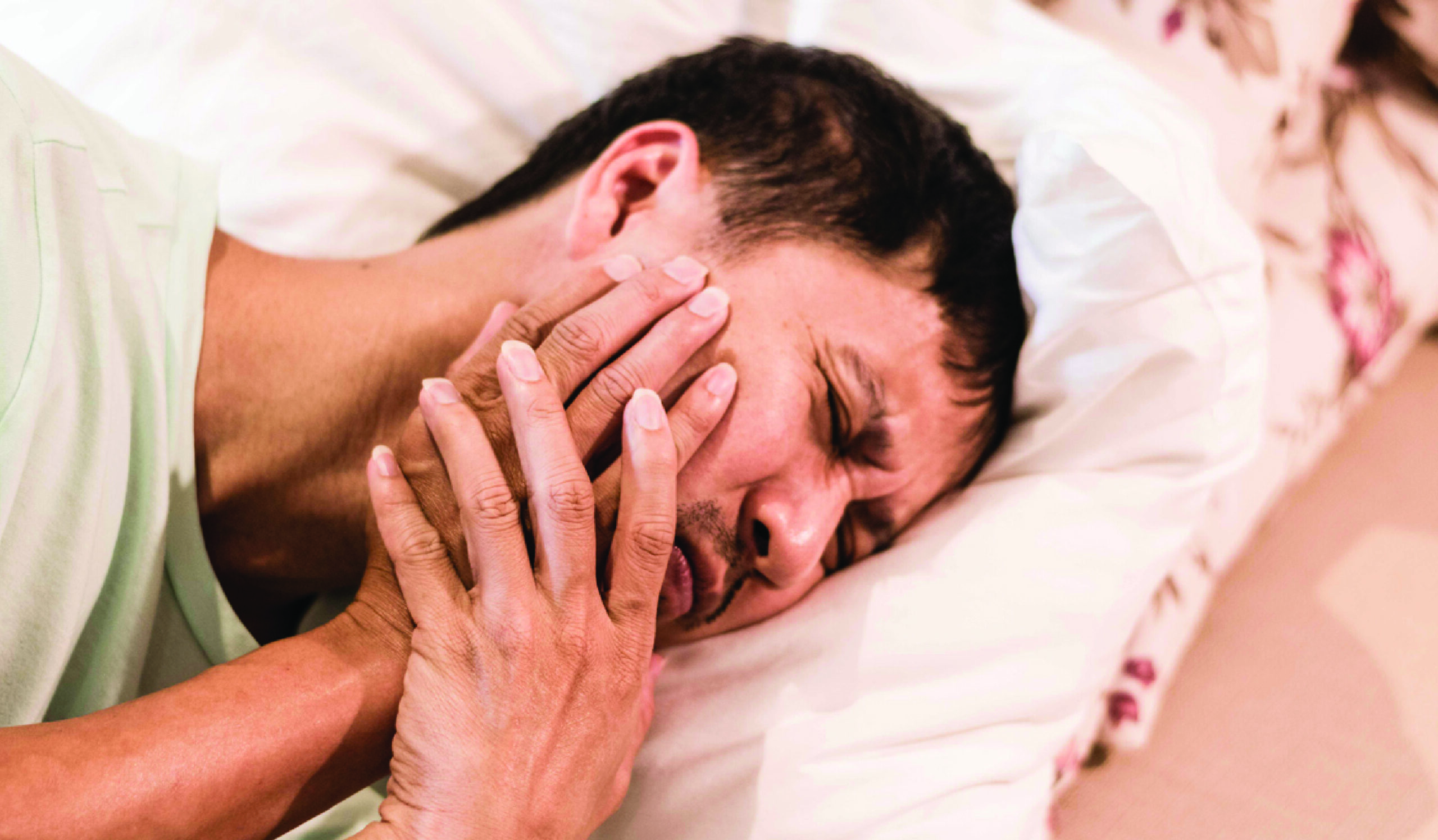 Man holding jaw with a concerned expression, indicating interest in Botox treatment for clenching or TMJ-related issues.