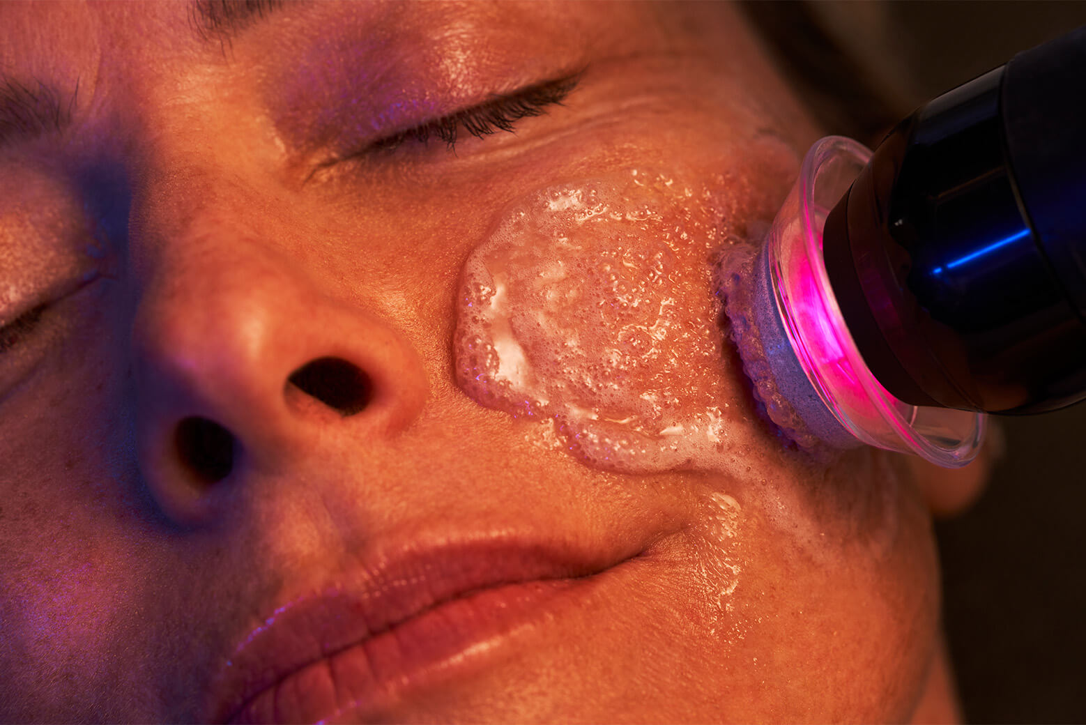 Young woman receiving a Glo2Facial treatment at Bloom Med Spa, enjoying a relaxing and rejuvenating skincare experience with advanced oxygenation technology.